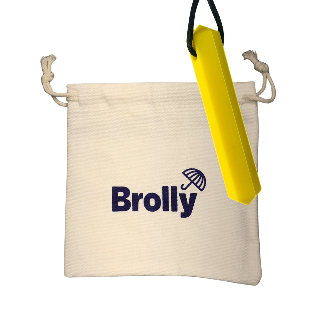 Beige drawstring pouch and Gem-shaped Brolly Chew Necklace on a black cord against a white background - Yellow