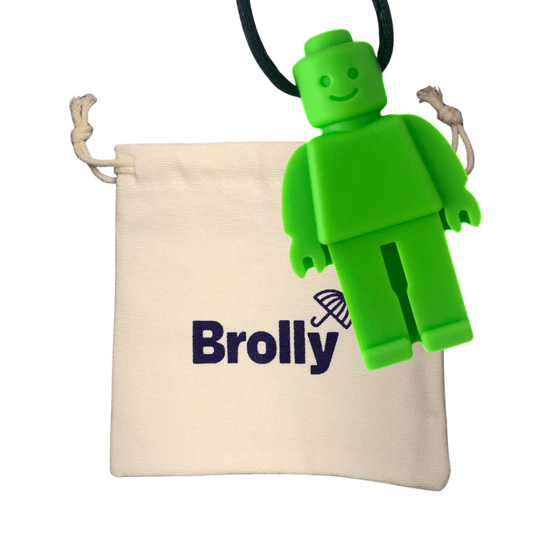 Beige drawstring pouch and Robot-shaped Brolly Chew Necklace on a black cord against a white background - Green