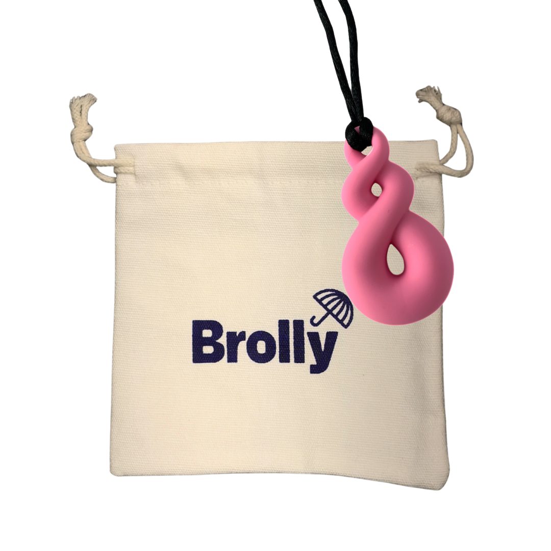 Beige drawstring pouch and Twist-shaped Brolly Chew Necklace on a black cord against a white background - Pink