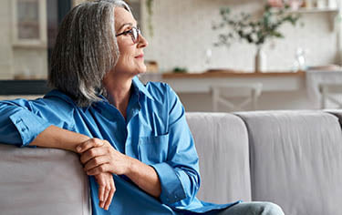 An older woman relaxing on a couch