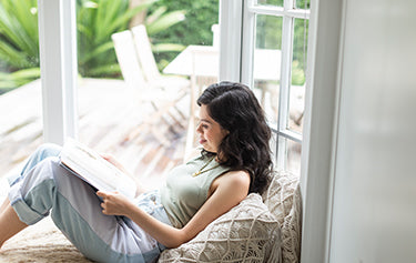 women reading a book & relaxing