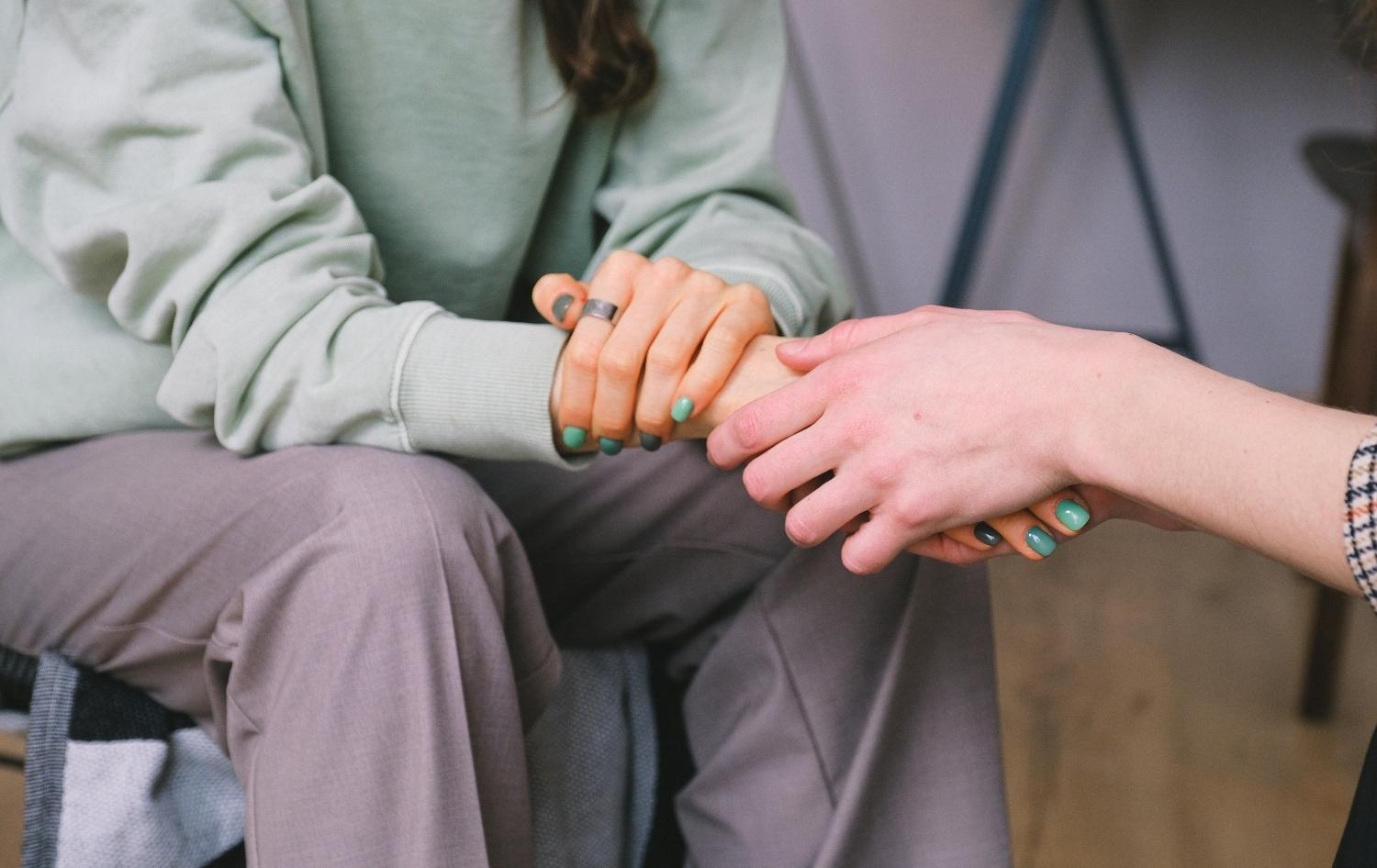 Women hand touch each other show support and care