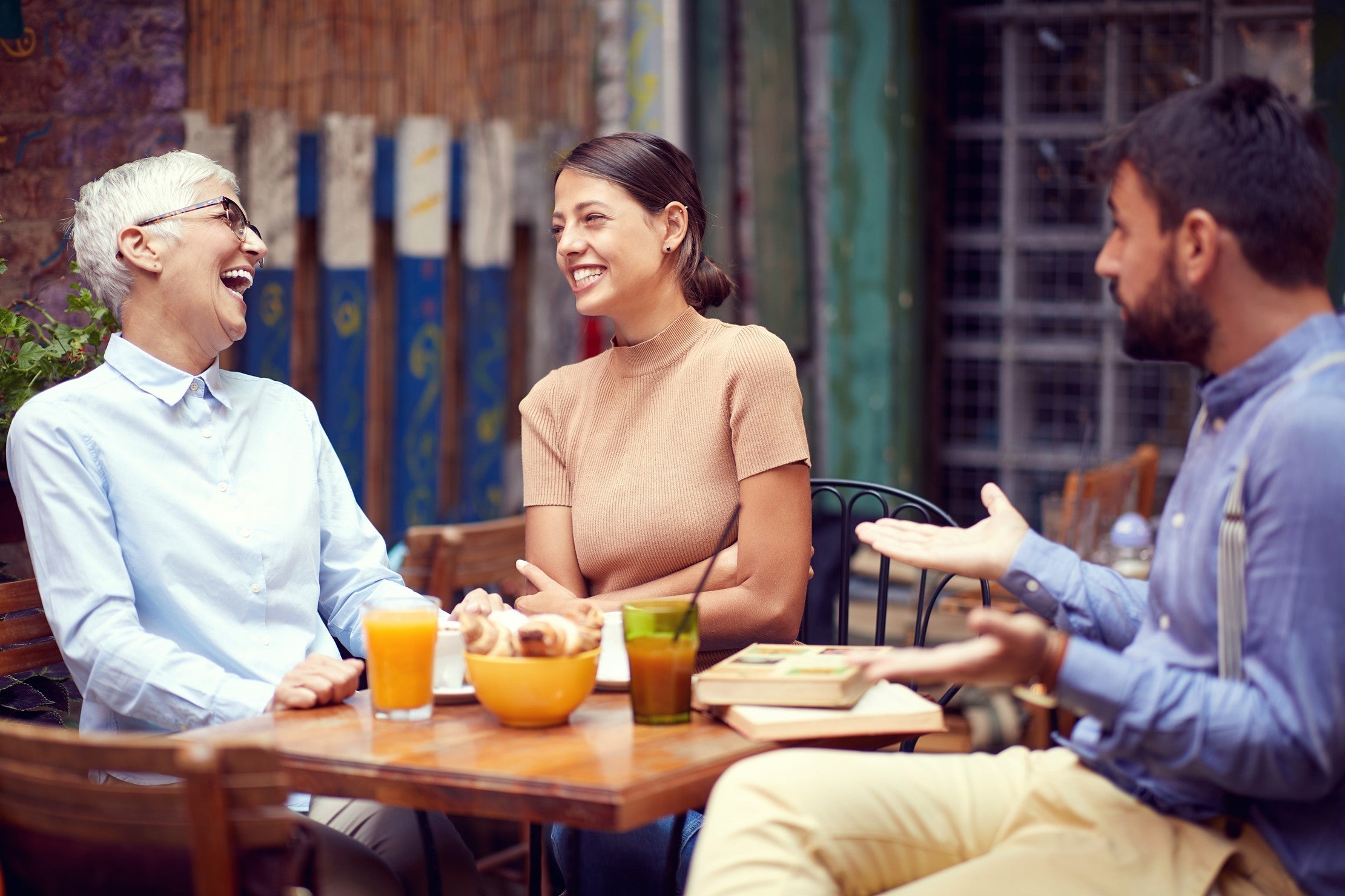 group of 3 friends talking and laughing confidently