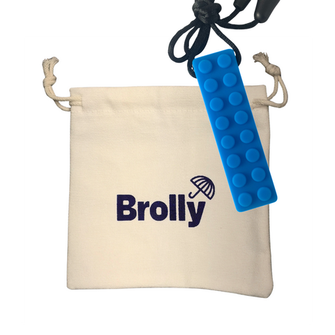 Beige drawstring pouch and Blue brick-shaped Brolly Chew Necklace on a black cord against a white background - Blue